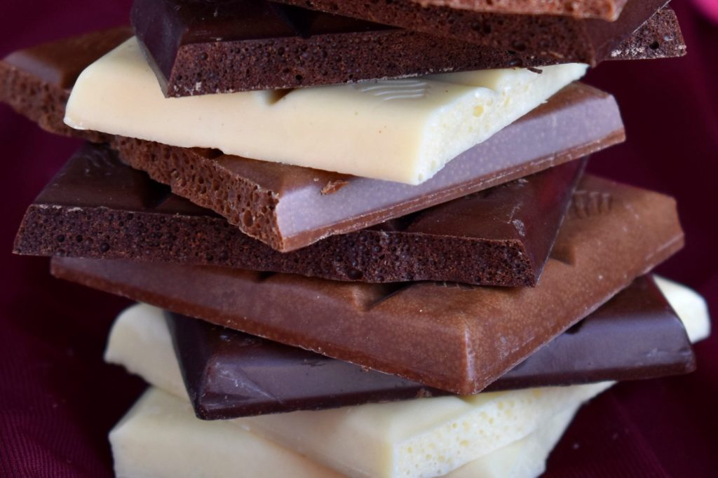 Some cubes of dark, milk, and white chocolate